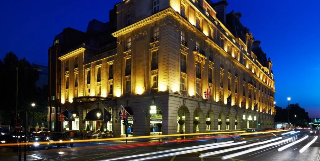 The Ritz London exterior illuminated at night.